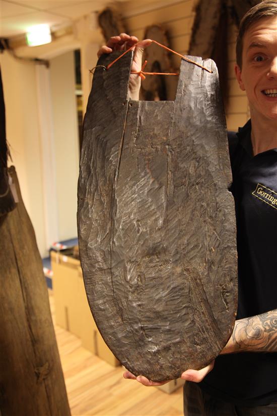 A Sepik River archers shield, another shield and three carved boards